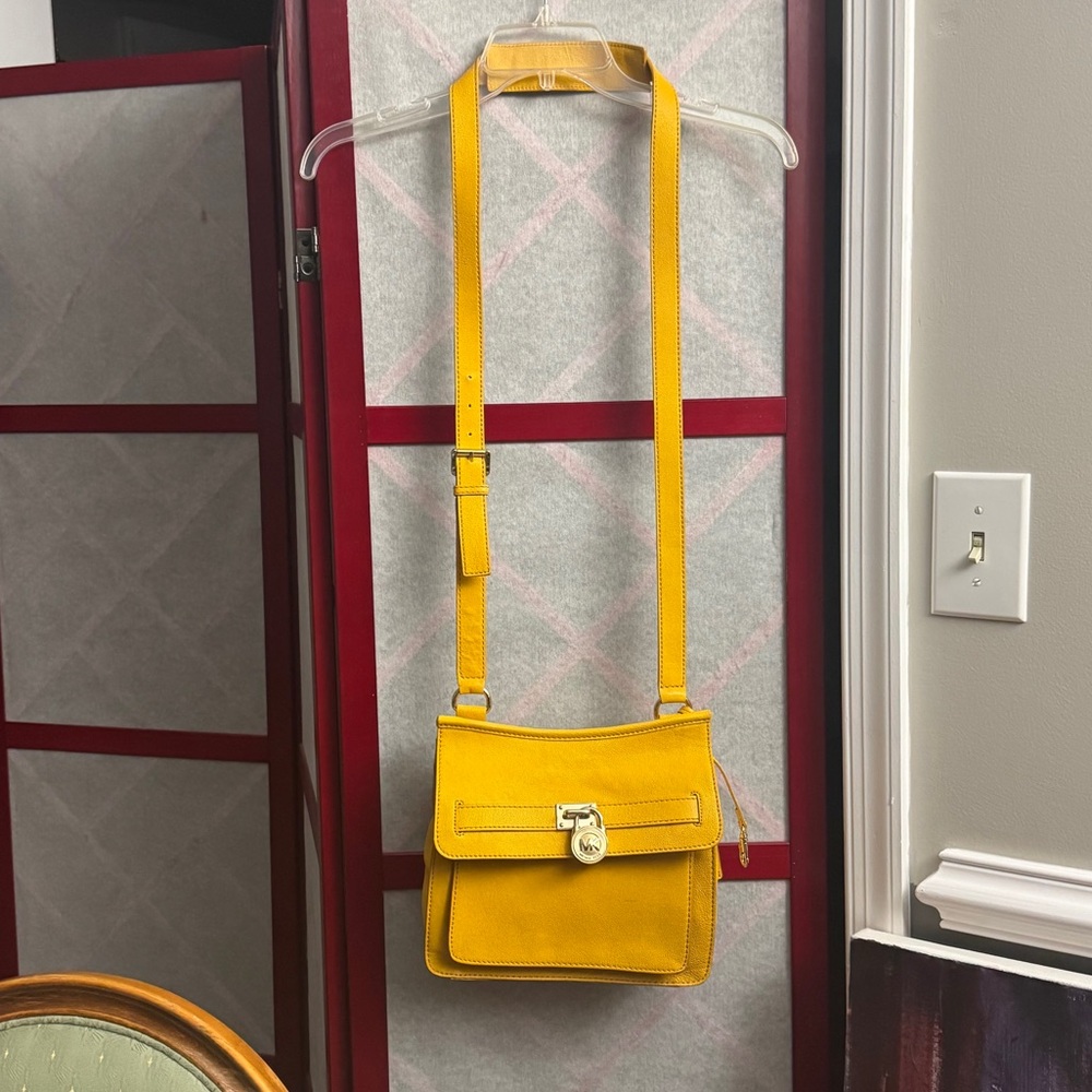 Miguel Kors small Leather Traveler Crossbody Bag.